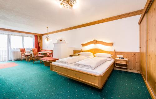 a bedroom with a bed and a table and chairs at Hotel Moserhof in Reutte