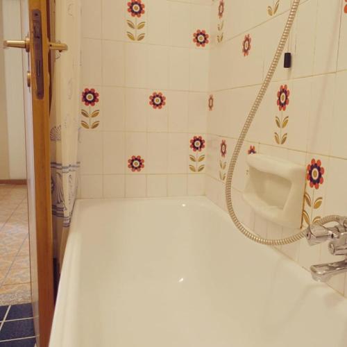 a bathroom with a sink and a shower curtain at House of cats in Domaso