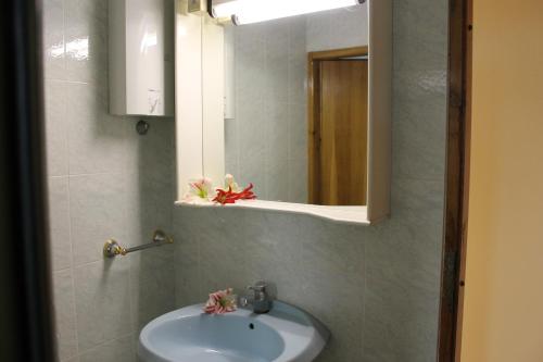 a bathroom with a sink and a mirror at Solar Apartments in Herceg-Novi