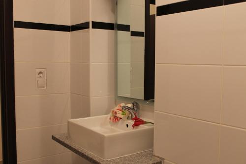 a bathroom with a white sink and a mirror at Solar Apartments in Herceg-Novi