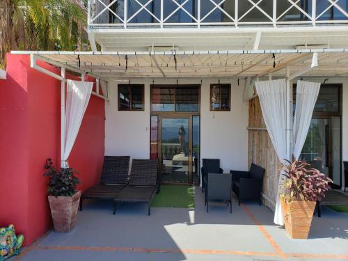 a patio with chairs and awning on a building at Pura Vista Hotel in Ocotal