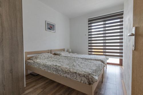 a bedroom with two beds and a window at Zeleno srce in Soko Banja