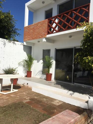 a house with a balcony with plants on it at Casa Jardin Rosarito in Rosarito