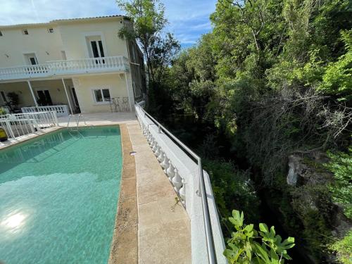 a swimming pool in front of a house at MOULIN DE L'OULETTE in Soubès