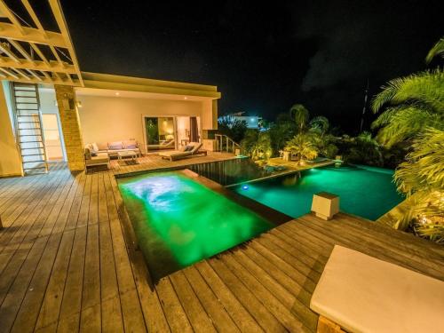 a swimming pool in a backyard at night at Villas Agua Dulce in Sosúa