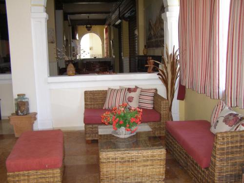 a living room with two couches and a table at PANTHEON HALL HOTEL in Mesongi