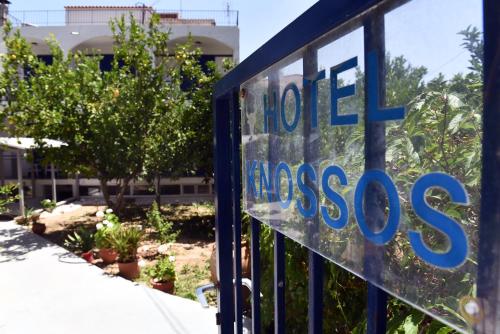 a sign for a hotelossess sign on a gate at Knossos Hotel in Tolo
