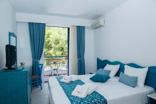 Ένα ή περισσότερα κρεβάτια σε δωμάτιο στο Ξενοδοχείο Κνωσσός