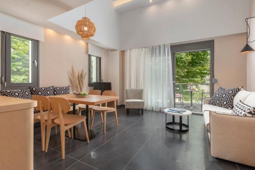 a living room with a table and a couch at ALPE LUXURY ACCOMMODATION Penelope Collection in Olympiada