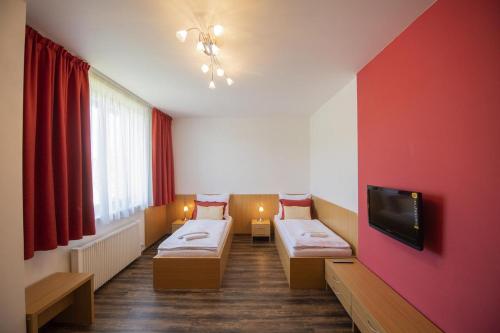 Postel nebo postele na pokoji v ubytování Hotel Berounka