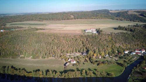 an aerial view of a house on a hill next to a river at Hotel Berounka in Hřebečníky