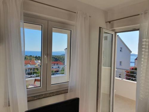 a room with two windows with a view of the ocean at Hvar De Luxe Apartments in Hvar