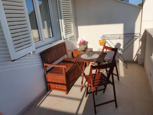 a balcony with a table and chairs and a window at Hvar De Luxe Apartments in Hvar