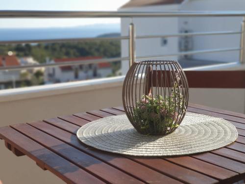 a plant in a basket sitting on a table at Hvar De Luxe Apartments in Hvar