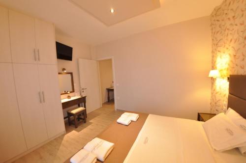 a bedroom with a bed and a desk in a room at Dina's Paradise in Agios Gordios