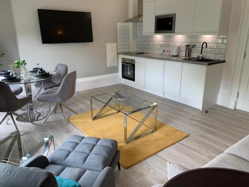a living room with a couch and a table at Winckley Square Residences in Preston