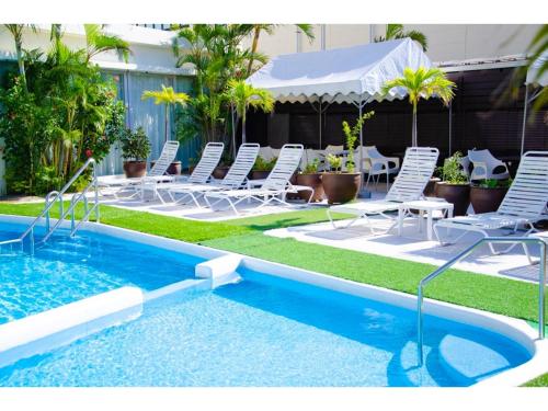 a pool with chairs and a table and a table and a pool at HOTEL GranView Garden OKINAWA - Vacation STAY 44961v in Tomigusuku