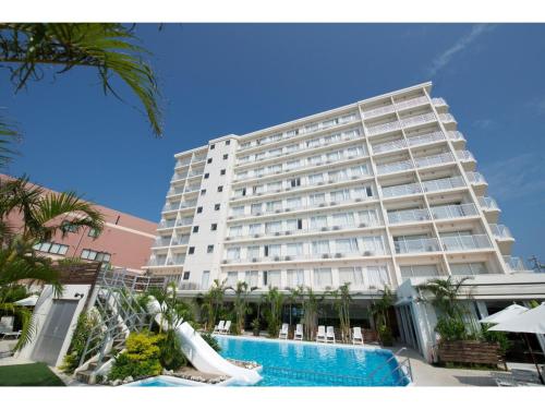 a large white building with a slide in front of it at HOTEL GranView Garden OKINAWA - Vacation STAY 44961v in Tomigusuku
