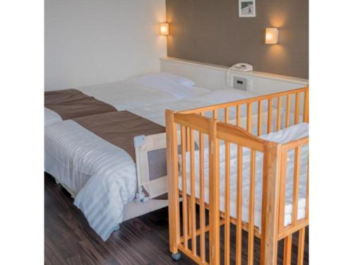 a bedroom with a large bed and a bunk bed at HOTEL GranView Garden OKINAWA - Vacation STAY 44964v in Tomigusuku