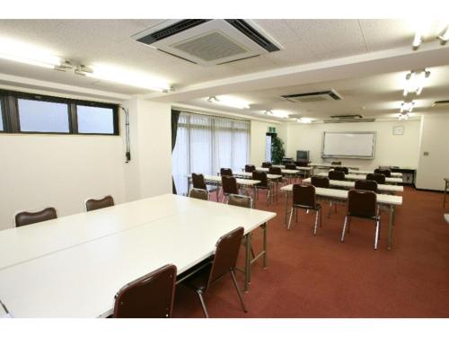 a room with tables and chairs in a classroom at Sky Heart Hotel Koiwa - Vacation STAY 49103v in Tokyo