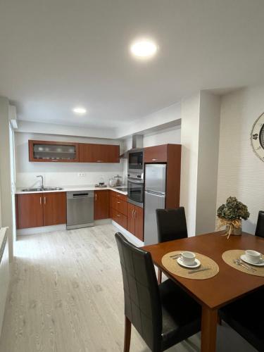 a kitchen and dining room with a table and chairs at Golden Views in Viveiro