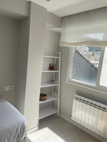 a bedroom with a bed and a window at Golden Views in Viveiro