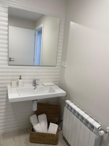 a bathroom with a sink and a mirror at Golden Views in Viveiro