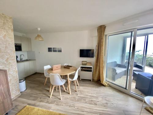 a kitchen and dining room with a table and chairs at Capveo in Pornichet