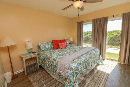 a bedroom with a bed and a large window at Creston House 12B in St. Augustine