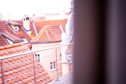 a balcony with a view of roofs at Anker Self-Check-In Hotel in Lindau