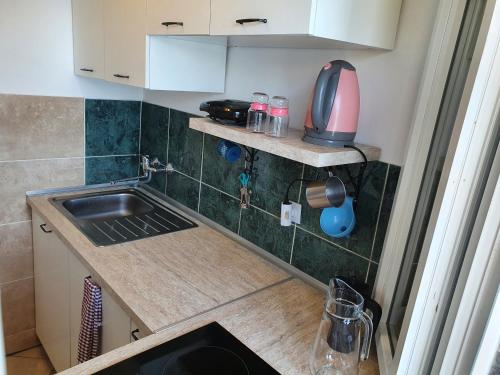 a small kitchen with a sink and a microwave at Sea House Bassi in Kraljevica