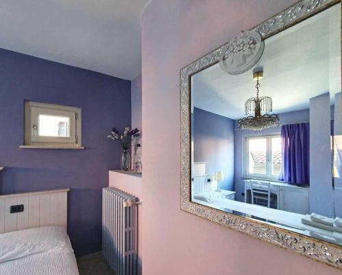 a bedroom with a mirror and a tub and a bed at Borgo alla Sorgente in Vallio Terme
