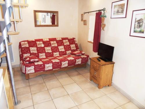 a bedroom with a bed and a television in it at le Sarto - St Jean de Maurienne in Saint-Jean-de-Maurienne