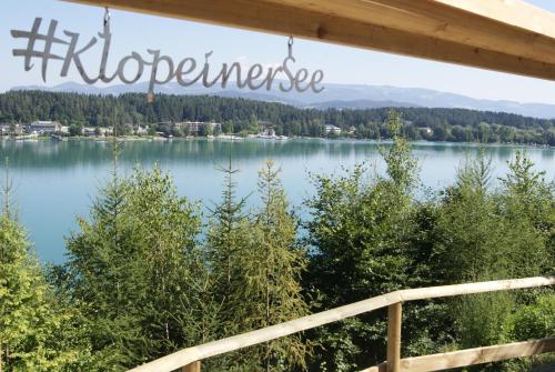 a view of a lake with a sign that reads wilderness at Ferienwohnungen Gerti in Klopein am Klopeiner See