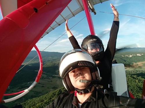 two boys in helmets are riding in a helicopter at Una SI in Lohovo