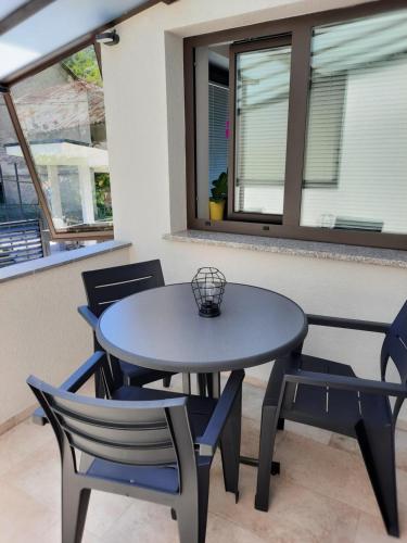 a table and two chairs and a table and two windows at Hiša Špuntar in Bovec