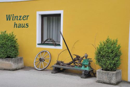 a yellow building with a fire hydrant and a window at Tennis Golf Hotel Höllrigl in Kottingbrunn