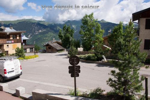 a parking lot with a car parked in the street at Courchevel 1550 – VERITABLE SKI AUX PIEDS – APPARTEMENT LES TOVETS T2 – 47m2 – 4P in Courchevel