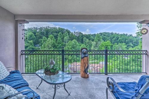 a patio with a table and a statue on a fence at Creekfront Bootleggers Hideaway! Walk to Dtwn! in Gatlinburg