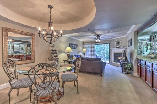 a dining room and living room with a table and chairs at Creekfront Bootleggers Hideaway! Walk to Dtwn! in Gatlinburg