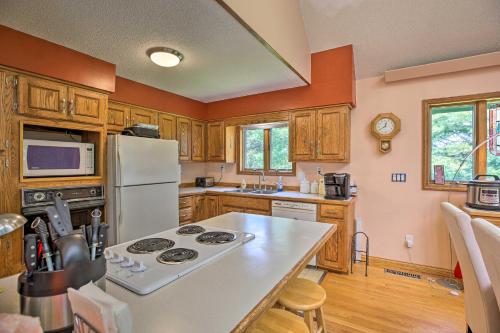 a kitchen with a stove and a white refrigerator at Lake Cumberland Home with Deck and Water Access! in Monticello