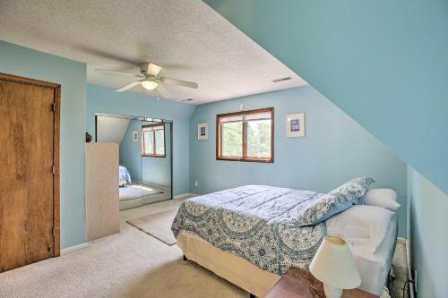 a blue bedroom with a bed and a ceiling fan at Lake Cumberland Home with Deck and Water Access! in Monticello