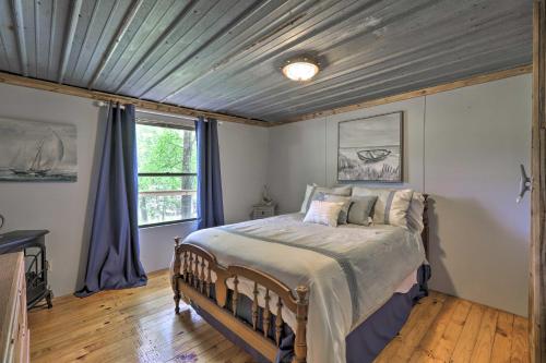 a bedroom with a bed and a wooden ceiling at Lake Sinclair House with Lake Access and Kayaks! in Milledgeville