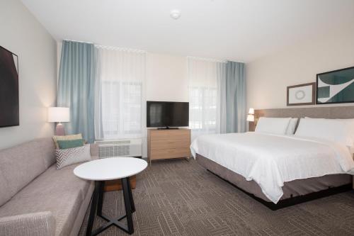 a hotel room with a bed and a couch at Staybridge Suites - Carson City - Tahoe Area by IHG in Carson City