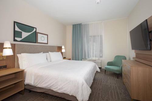 a hotel room with a bed and a television at Staybridge Suites - Carson City - Tahoe Area by IHG in Carson City