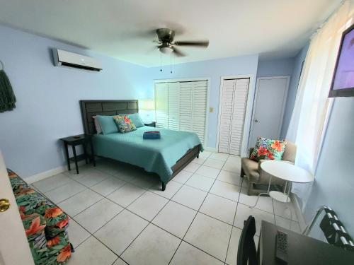 a bedroom with a bed and a table and a chair at La Casona Azul in Miami