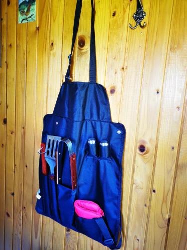 a blue bag is hanging on a wooden wall at MERIKOTKA - a cozy wooden cottage, sLOVEnia in Braslovče