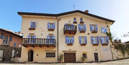a large building with blue windows and balconies on it at Borgo alla Sorgente in Vallio Terme