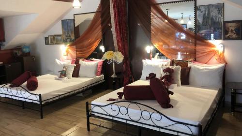 two beds sitting in a room at Gabi Guesthouse in Constanţa