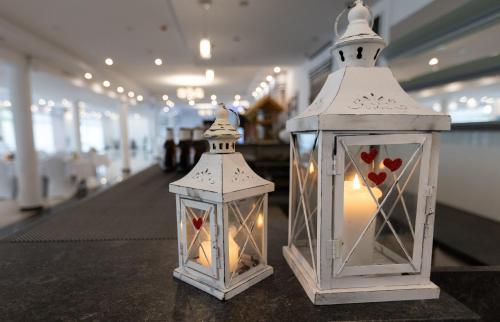 two lanterns sitting on a table in a store at Kresovia in Giby